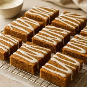 Soft gingerbread cookie bars with vanilla icing